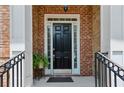 Beautiful brick home featuring a black front door framed by white columns at 2969 Rivergreen Se Ln # 23, Atlanta, GA 30339