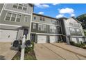 Desirable townhome exterior boasting an attached garage, green lawn, and easy access to the neighborhood at 3014 Liberty Nw Way, Atlanta, GA 30318