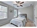 Cozy bedroom with natural light from two windows at 711 Topsail Ln, Alpharetta, GA 30005