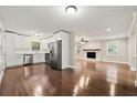 Open-concept living area with an eat-in kitchen and a fireplace at 4110 Oak Ferry Ne Dr, Kennesaw, GA 30144