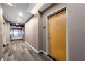 Well-lit hallway with patterned carpet, neutral walls, and unit entrance door at 860 Peachtree Ne St # 1912, Atlanta, GA 30308