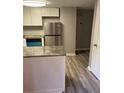Bright kitchen featuring stainless steel appliances, granite counters, and wood-look flooring at 1150 Rankin Street # D1, Stone Mountain, GA 30083