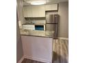Well-lit kitchen featuring stainless steel appliances, granite counters, and white cabinets at 1150 Rankin Street # D1, Stone Mountain, GA 30083
