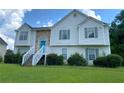 Charming two-story home with stone accents, blue door, and landscaped front yard at 3059 Brass Dr, Austell, GA 30106