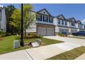 Row of well-manicured townhouses with attached garages and landscaped front yards at 4098 Haleston Rd, Duluth, GA 30097