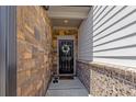 Inviting entryway featuring a decorative wreath on a black front door and a brick facade at 4098 Haleston Rd, Duluth, GA 30097