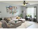 Comfortable living room featuring a sectional sofa, accent chairs, and large windows at 4172 Howell Park Road, Duluth, GA 30096