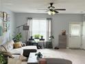 Bright living room with large windows, neutral walls, and stylish furnishings at 4172 Howell Park Road, Duluth, GA 30096