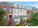 Row of townhomes featuring brick and painted facades, each with unique architectural details and entry staircases at 6459 Chariot St # 35, Atlanta, GA 30328
