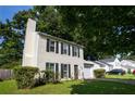 Two-story home with black shutters, well-kept lawn, and driveway with garage at 1377 Mill Lake Cir, Stone Mountain, GA 30088