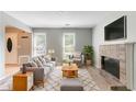Bright living room with neutral walls, a brick fireplace, and lots of natural light at 1377 Mill Lake Cir, Stone Mountain, GA 30088