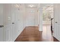 Bright foyer features hardwood floors, white trim, and arched doorway into adjacent room at 2090 Beckham St, Cumming, GA 30041