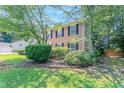 Brick home with black shutters and professional landscaping at 1797 Emerson Lake Cir, Snellville, GA 30078