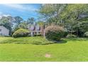 Well-maintained two-story home with a lush green lawn and mature landscaping at 1797 Emerson Lake Cir, Snellville, GA 30078
