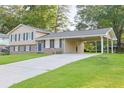 A well-maintained home with a spacious driveway leading to a convenient carport, perfect for easy access at 130 Mimosa Dr, Fayetteville, GA 30214