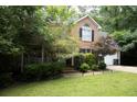 Beautiful two-story brick home with lush greenery and a two-car garage, exuding a welcoming atmosphere at 1473 Wildwood Way, Hampton, GA 30228