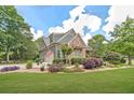 Well-manicured lawn and lush landscaping complement this beautiful home with an attached garage at 2010 Bennett Rd, Grayson, GA 30017