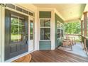 Inviting covered front porch with classic rocking chairs, creating a cozy and welcoming entrance at 2010 Bennett Rd, Grayson, GA 30017