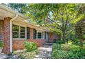 Brick exterior of the house with windows and neat landscaping along the walkway at 3746 Gladney Dr, Atlanta, GA 30341