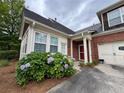 This home features a brick exterior, a red front door, and beautiful hydrangea bushes in the front yard at 1604 Haven Cir, Douglasville, GA 30135