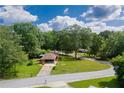 Aerial view of a charming single-story house with a long driveway and mature trees surrounding the property at 3888 Lindley Cir, Powder Springs, GA 30127