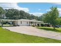 Ranch style home featuring a large front yard, a covered carport, and brick and siding exterior at 6160 King Arthur Dr, Douglasville, GA 30135