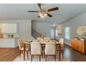 Inviting dining room featuring stylish furnishings, a ceiling fan, and hardwood floors at 173 Parkview Place Dr, Mcdonough, GA 30253