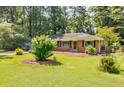 Well-maintained brick home with a lush green lawn and mature shade trees at 2343 Hunting Valley Dr, Decatur, GA 30033