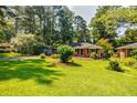 Well-maintained brick home with a lush green lawn and mature shade trees at 2343 Hunting Valley Dr, Decatur, GA 30033