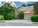 Lovely brick home with well-kept lawn, two-car garage and mature landscaping at 3423 Mulberry Lane Ct, Dacula, GA 30019