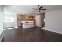 Open concept living space showcasing hardwood floors, neutral walls, and a modern kitchen with a large island at 4435 Beechnut Cir, Cumming, GA 30028