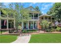 Charming two-story home featuring a double front porch and a well-manicured lawn with black metal fence at 659 Holcomb Bridge Rd, Norcross, GA 30071