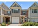 Charming two-story townhouse with a well-manicured front yard in daylight at 299 Azalea Cir, Cumming, GA 30040