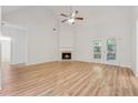 Spacious living room with wood floors, a fireplace, and French doors that let in natural light at 384 Daniel Mill Xing, Villa Rica, GA 30180