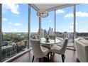 Contemporary dining area with a modern chandelier and an attractive city view as backdrop, perfect for intimate meals at 1080 Peachtree Ne St # 2710, Atlanta, GA 30309