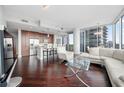 Open-concept living area blending a modern kitchen with a comfortable lounge, featuring sleek cabinetry and contemporary decor at 1080 Peachtree Ne St # 2710, Atlanta, GA 30309