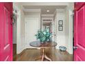 Welcoming foyer with hardwood floors, a center table with flowers, and neutral wall colors at 4045 Boles Creek Dr, Duluth, GA 30096