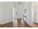 Bright and airy entryway featuring stylish decor, light hardwood flooring, and a view into the open-concept living spaces at 4369 Milford Pl, Hoschton, GA 30548