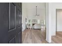 Inviting entryway that displays an open-concept design and hardwood floors, transitioning into the light-filled living area at 4369 Milford Pl, Hoschton, GA 30548