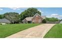 An eye-level side-view of an attractive home with a well-kept lawn and long driveway at 4369 Milford Pl, Hoschton, GA 30548