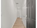 Bright hallway with wood-look flooring and white trim, leading to additional rooms at 4451 Manor Hill Dr, Union City, GA 30291