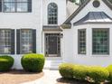 Elegant front entrance with a gray front door and well-maintained landscaping at 1630 Reindeer Rdg, Alpharetta, GA 30005
