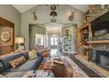 Cozy living room featuring a stone fireplace, hardwood floors, and comfortable seating at 416 Spring Place Ne Rd, White, GA 30184