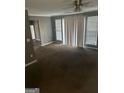 A bright living room with natural light, neutral walls and carpet flooring at 6470 Bedford Ln, Lithonia, GA 30058