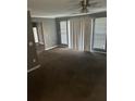Neutral living room featuring a ceiling fan, neutral carpet and bright windows at 6470 Bedford Ln, Lithonia, GA 30058