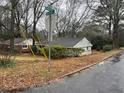 A charming house sits on a tree-lined street, blending into the neighborhood at 1088 Palafox Ne Dr, Atlanta, GA 30324