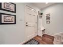 Bright entryway with hardwood floors, a white front door, coat rack, and decorative wall art at 3440 Ashwood Ln, Atlanta, GA 30341