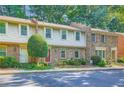 Charming townhouse with shake siding, brick accents, a well-manicured lawn, and a vibrant red front door at 3440 Ashwood Ln, Atlanta, GA 30341