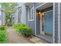 Welcoming blue front door entrance with brick steps and a well-maintained garden pathway at 836 Saint Charles Ne Ave # I, Atlanta, GA 30306