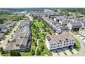 An aerial view showcasing the neighborhood with green spaces, sidewalks, and varied home styles at 6930 Whitman Walk, Alpharetta, GA 30005
